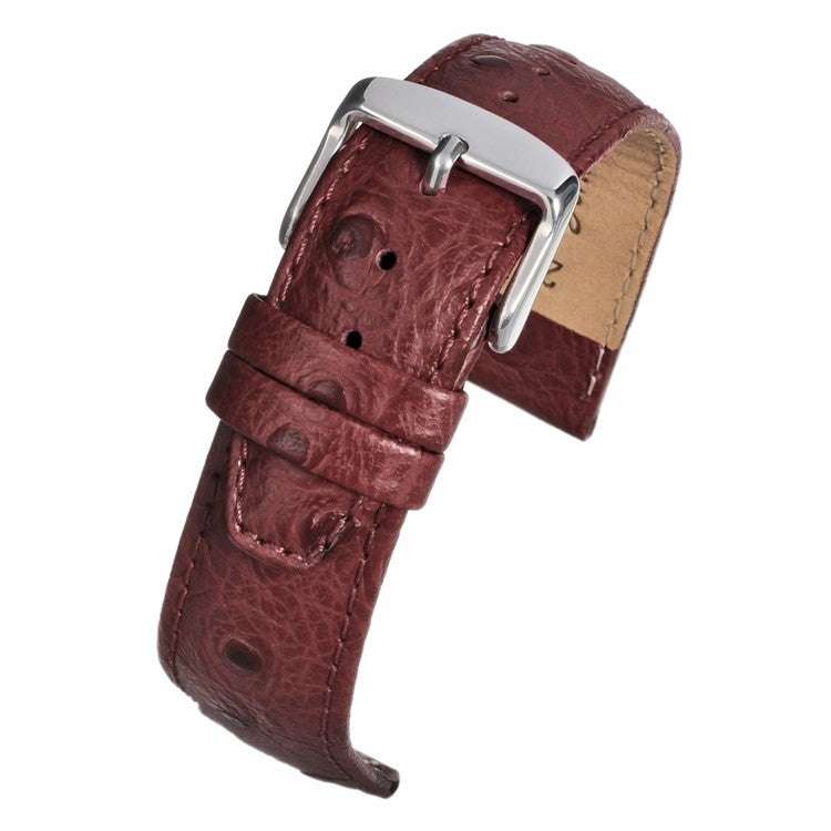 Vibrant ostrich grain leather watch strap with distinctive quill follicle texture, color-matched stitching, and stainless steel buckle.