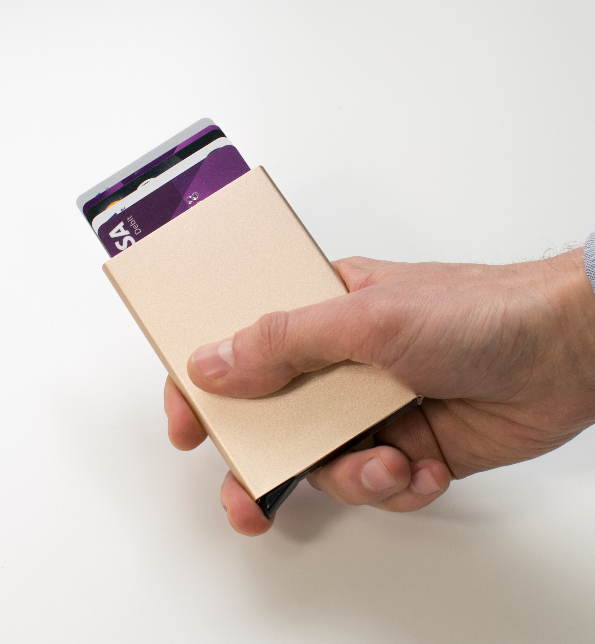 RFID blocking aluminum wallet with cards in hand, showcasing modern minimalist design.